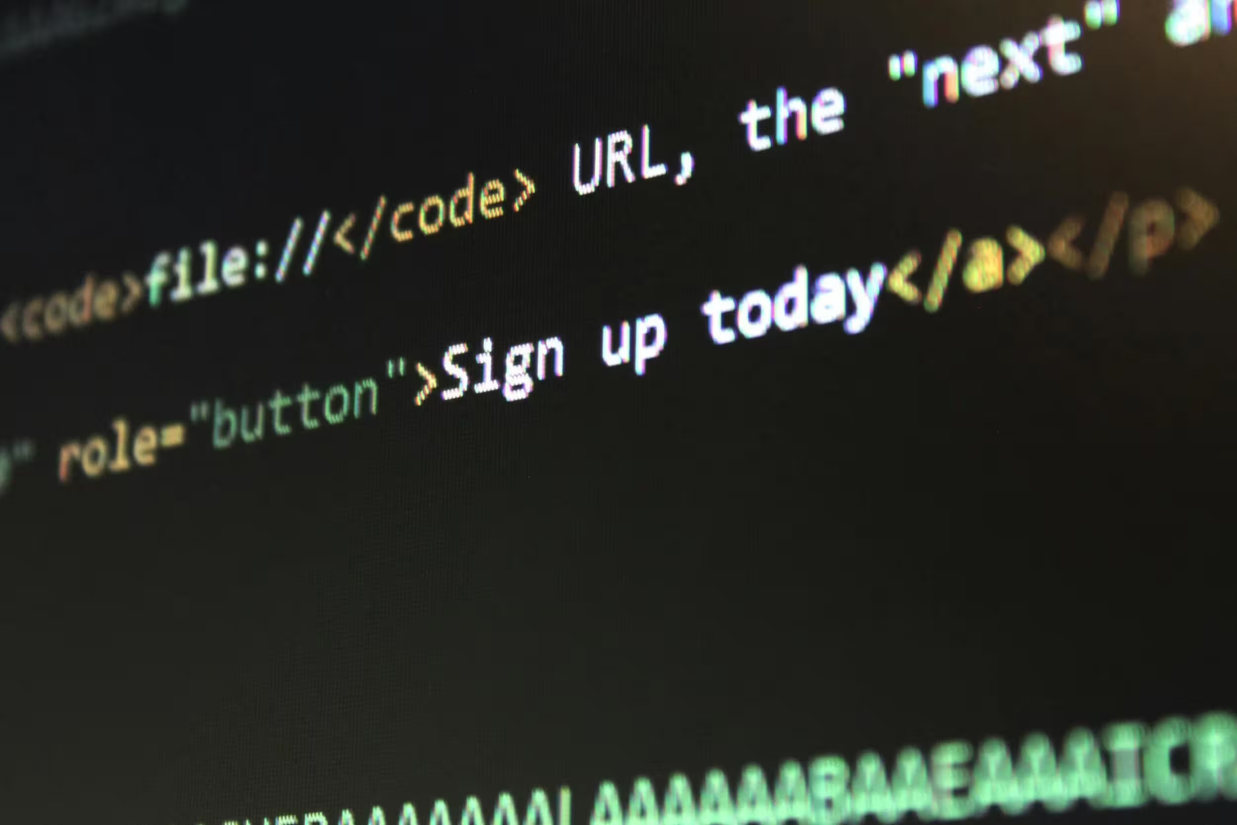Website code is displayed on a monitor, with a slight blur towards the edges.